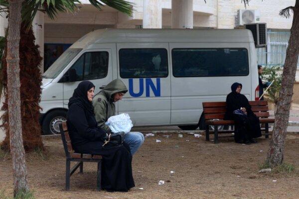 Displaced Palestinian people sit on benches as they wait outside a clinic of the U.N. Relief and Works Agency for Palestine Refugees (UNRWA) in Rafah in the southern Gaza Strip on Jan. 28, 2024. (AFP via Getty Images)