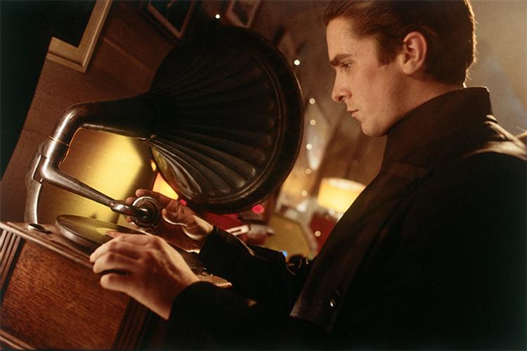 John Preston (Christian Bale) fumbles with and turns on a Victrola, in "Equilibrium." (MovieStillDB)