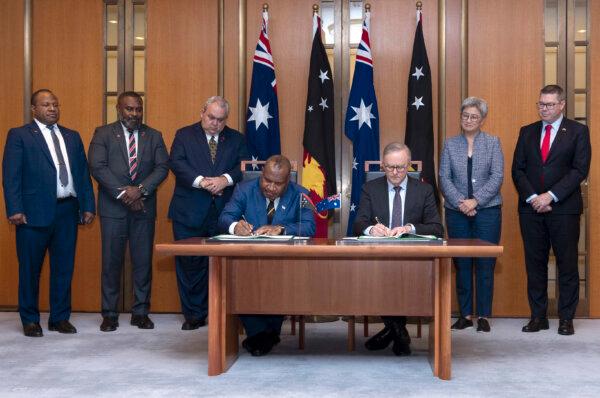 Australia's Prime Minister Anthony Albanese (3rd R) participates in an official signing ceremony with Papua New Guinea's Prime Minister James Marape (C) in Canberra, Australia, on Dec. 7, 2023. (Hilary Wardhaugh/AFP via Getty Images)