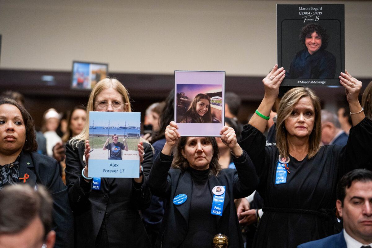 Parents hold photos of children who passed away ahead of the social media CEO’s testimony about big tech and the online child sexual exploitation crisis before the Senate Judiciary Committee in Washington on Jan. 31, 2024. (Madalina Vasiliu/The Epoch Times)