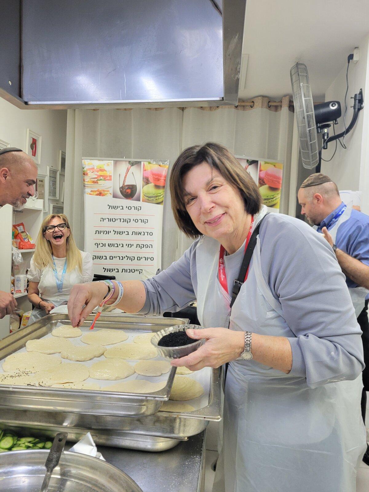 Beth Arogeti, board chairman of the Jewish Federation of Greater Atlanta, bakes pita bread in Tel Aviv on a Momentum Unity mission to Israel in January 2024. (Courtesy of Bethann Johnston.)