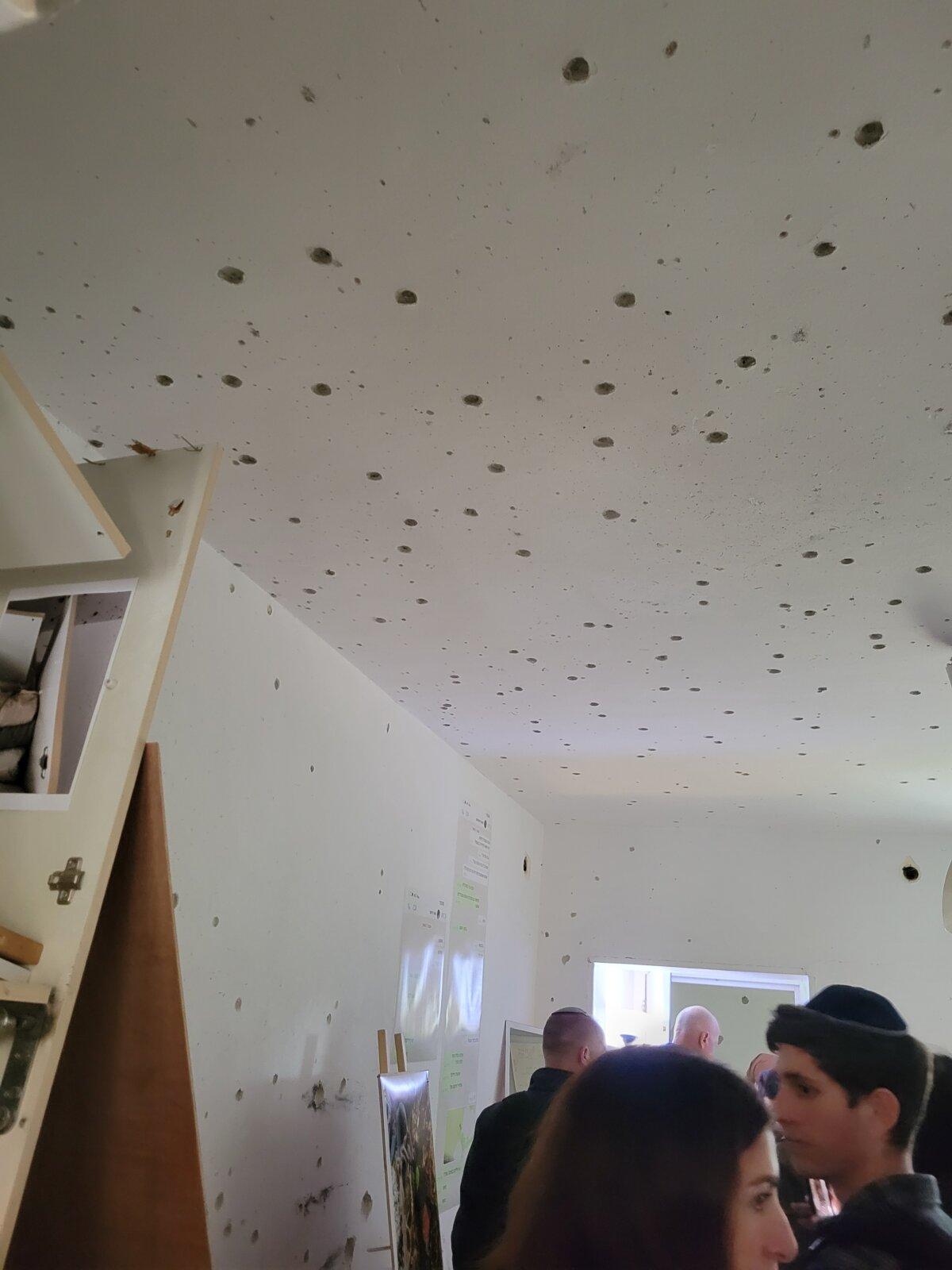 Momentum volunteers supporting Israel are in a house riddled with bullet holes while on a tour of Kfar Aza, a kibbutz destroyed by Hamas on Oct. 7, 2023. (Courtesy of Bethann Johnston.)