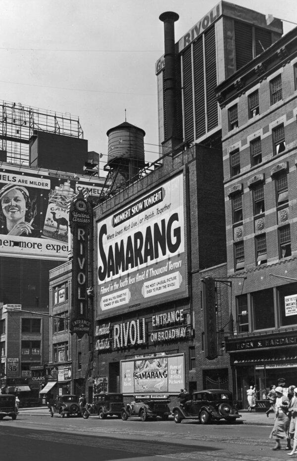 View of billboards outside the United Artists Rivoli Theater on the west side of Seventh Avenue at West 49th Street, Times Square, midtown Manhattan, New York City, circa 1933. The billboards promote Camel cigarettes and director Ward Wing's film, "Samarang." (P. L. Sperr/Hulton Archive/Getty Images)