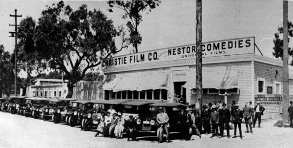 The first motion picture studio in Hollywood was built for Christie Film Co. Automobiles are lined up at Sunset Blvd., with Gower Street at right, circa 1913. (Public Domain)