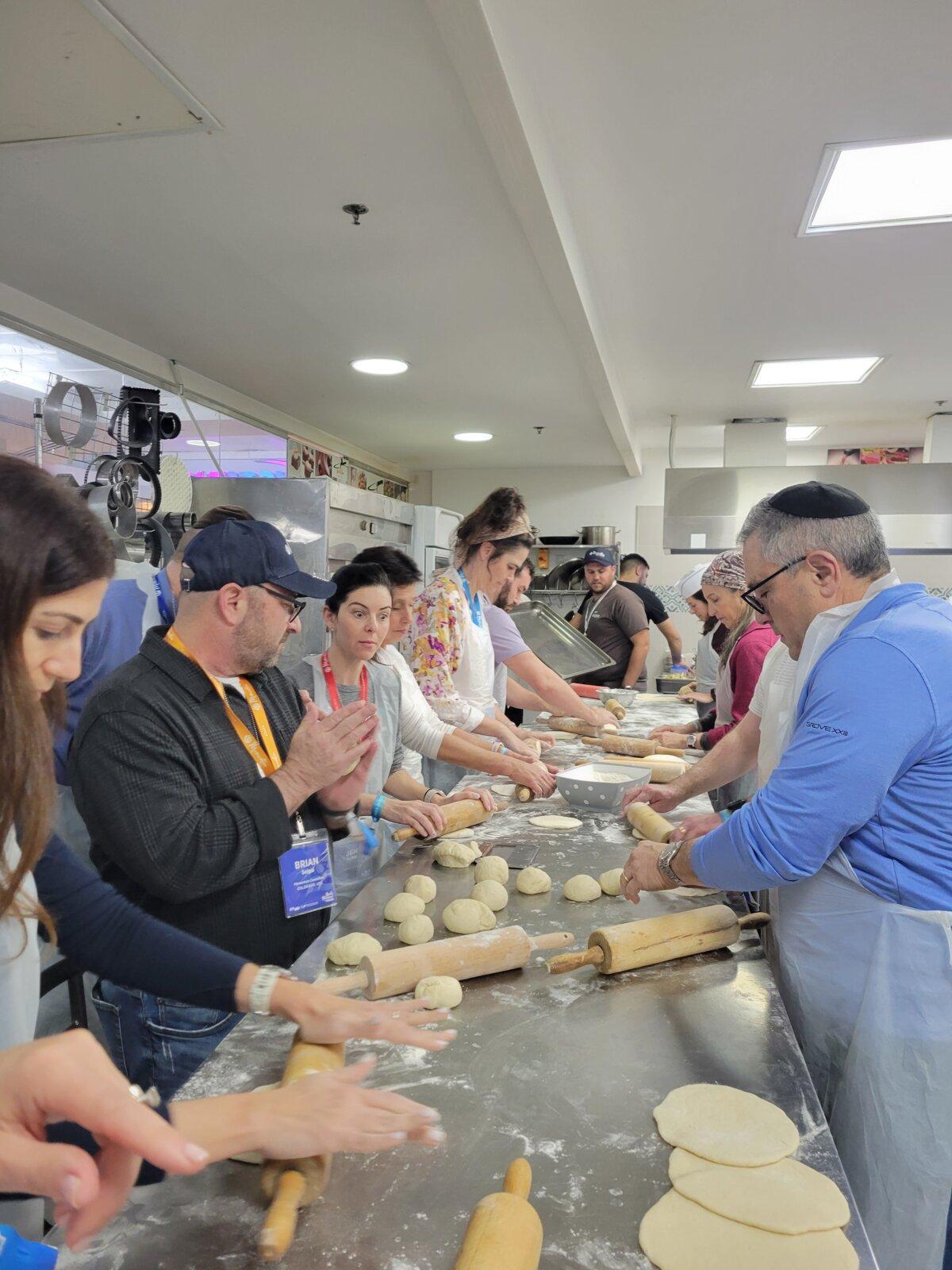 Momentum Unity volunteers bake pita bread in Tel Aviv in January 2024. (Courtesy of Bethann Johnston.)