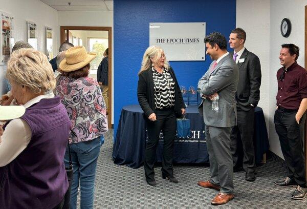 Penny Pew (C), district director of Rep. Paul Gosar (R-Ariz.) speaks with Siyamak Khorrami, general manager of The Epoch Times' Southern California office at the ribbon cutting ceremony for the Arizona office in Tempe, Ariz., on Jan. 25, 2024. (Charlie Chang/The Epoch Times)