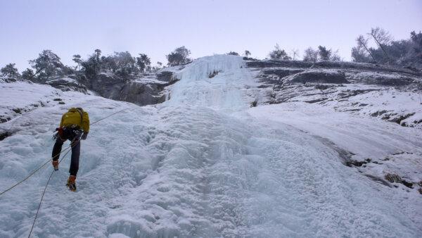 A mountain guide rappels down a steep frozen waterfall. (Dreamstime/TNS)