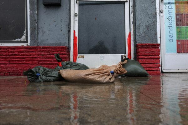 Sandbags are placed on a flooded sidewalk during a rain storm in Long Beach, Calif., on Feb. 1, 2024. (David Swanson/AFP via Getty Images)