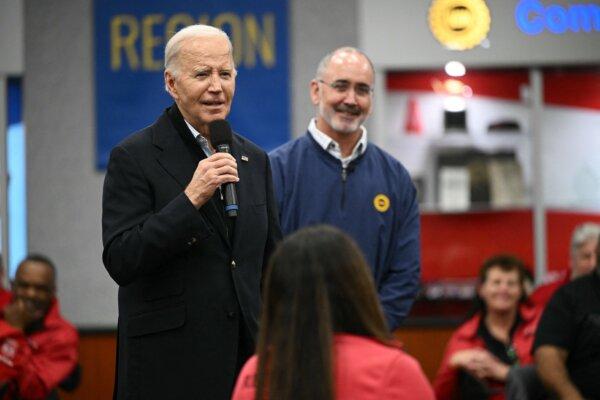 President Joe Biden speaks to members of the United Auto Workers as UAW President Shawn Fain looks on at the union's National Training Center, in Warren, Mich., on Feb. 1, 2024. (Mandel Ngan/AFP)