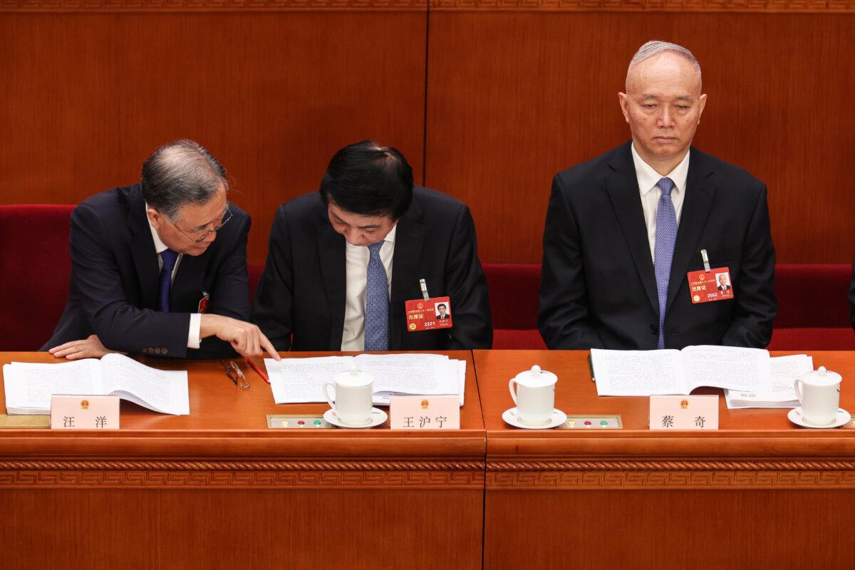 (L-R) Delegates Wang Yang, Wang Huning, and Cai Qi attend the opening of the first session of the 14th National People's Congress at The Great Hall of People in Beijing, on March 5, 2023. (Lintao Zhang/Getty Images)