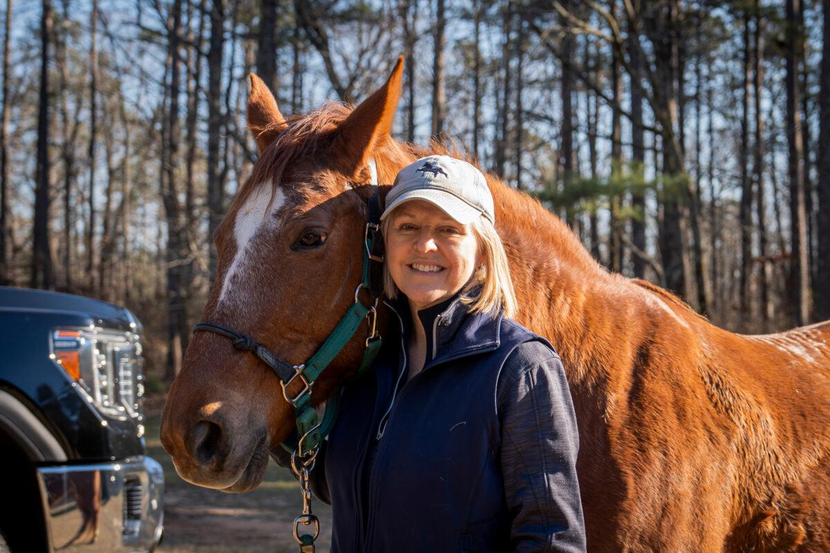 Cindy James, a South Carolina voter with her horse Stetson, speaks during an interview with The Epoch Times in Buncombe Horse Trailhead, Whitmire, S.C., on Feb. 3, 2024. (Madalina Vasiliu/The Epoch Times)