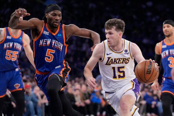 Los Angeles Lakers' Austin Reaves (15) drives past New York Knicks' Precious Achiuwa (5) during the first half of an NBA basketball game in New York City on Feb. 3, 2024. (Frank Franklin II/AP Photo)