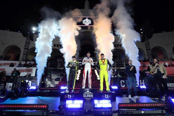Denny Hamlin (C) winner, Kyle Busch (R) second place, and Ryan Blaney (L) third place, pose on the podium in victory lane after the NASCAR Cup Series Busch Light Clash in Los Angeles on Feb. 3, 2024. (Meg Oliphant/Getty Images)