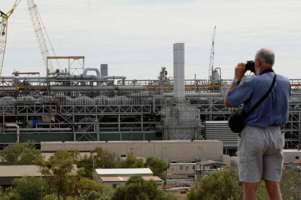 A tourist photographs the gas production area at the Woodside operated North West Shelf Gas Venture in Western Australia, on June 16, 2008. (Greg Wood/AFP via Getty Images)
