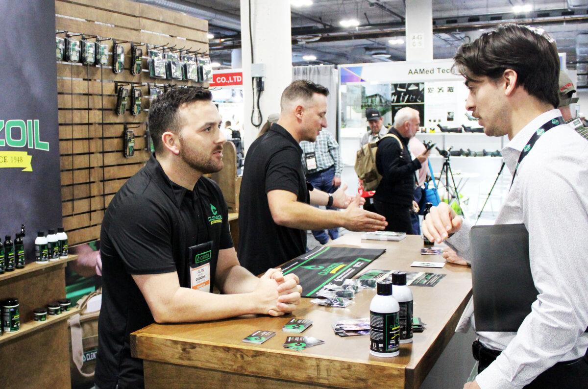 Alan Moloney of Clenzoil talks with a potential customer during the Shooting, Hunting, Outdoors Trade Show in Las Vegas, Nev. on Jan. 25, 2024. (Michael Clements/The Epoch Times)