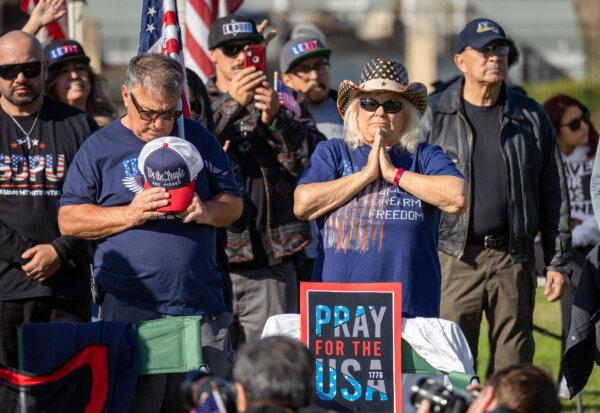 Participants of a convoy protesting U.S. border policies pray together in San Ysidro, Calif., on Feb. 3, 2024. (John Fredricks/The Epoch Times)