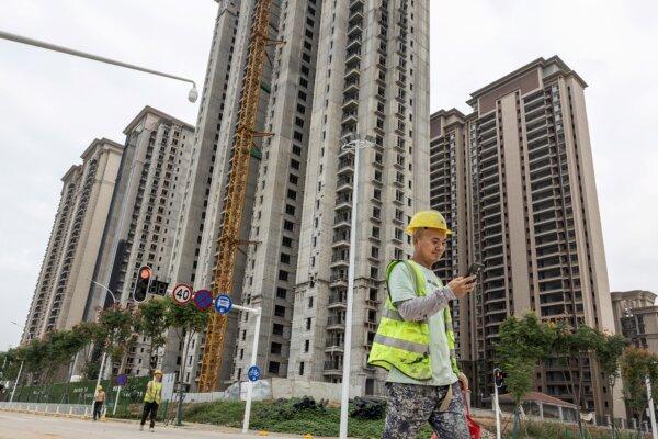 A worker walks past a housing complex under construction by Chinese property developer Evergrande in Wuhan, in China's Hubei Province, on Sept. 28, 2023. (STR/AFP via Getty Images)