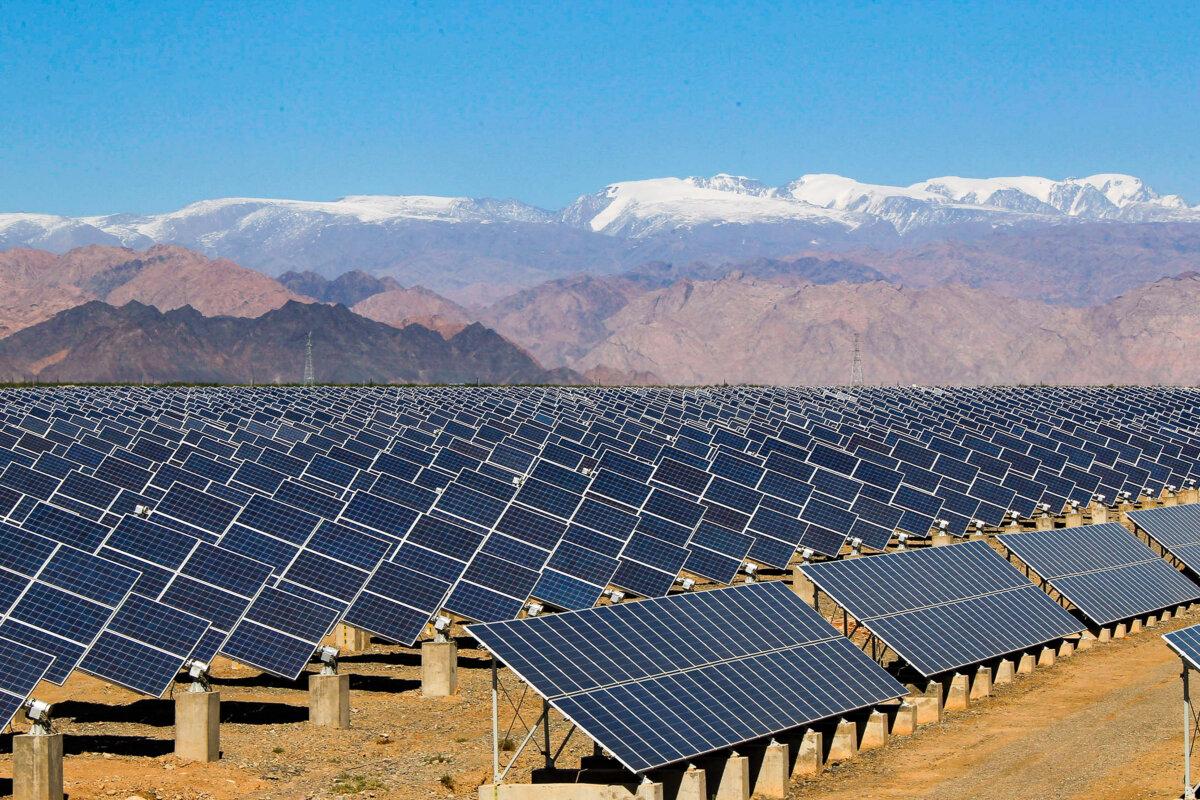Large solar panels are seen in a solar power plant in Hami, northwest China's Xinjiang region, on May 8, 2013. (STR/AFP via Getty Images)