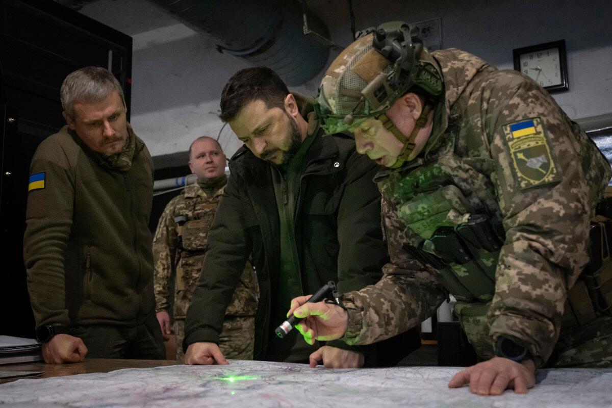 Ukrainian President Volodymyr Zelenskyy and Commander of Ukraine's Ground Forces Col. Gen. Oleksandr Syrsky look at a map during their visit to the frontline city of Kupiansk, Kharkiv, Ukraine, on Nov. 30, 2023. (Efrem Lukatsky/AP Photo)