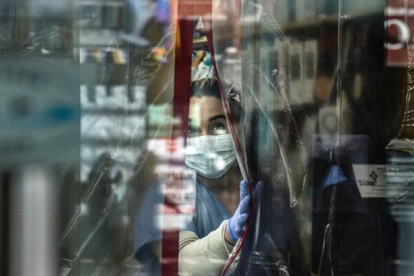 A pharmacist works while wearing personal protective equipment in the Elmhurst neighborhood in New York City on April 1, 2020. (Stephanie Keith/Getty Images)