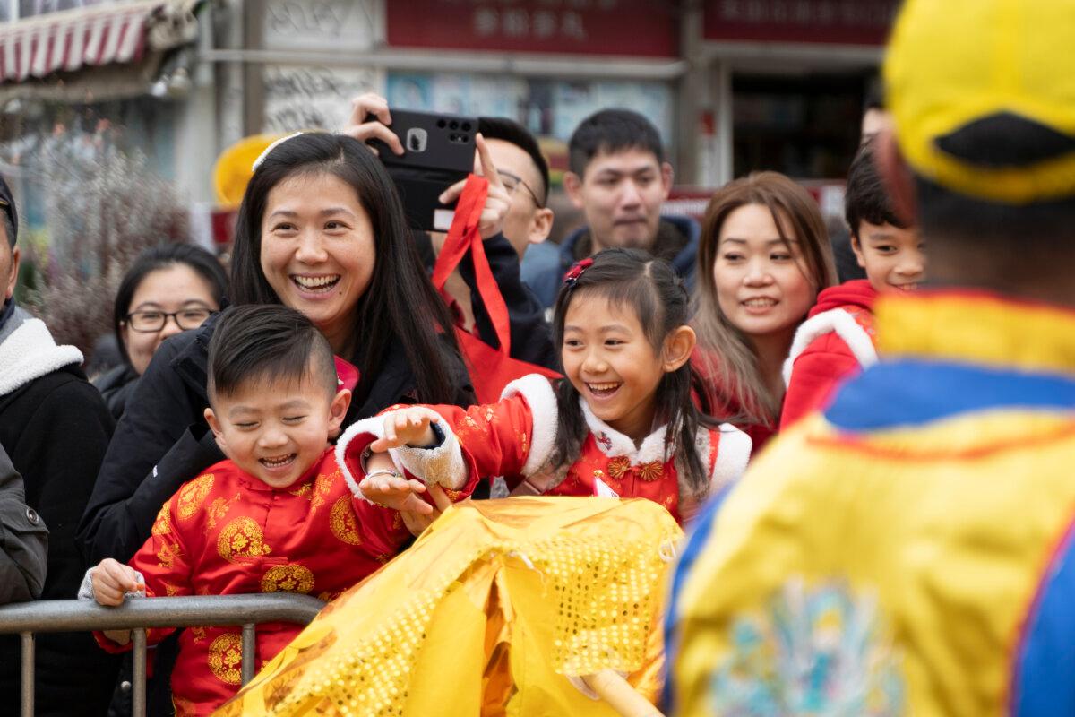 Falun Gong practitioners attend a parade celebrating the Chinese New Year in the Flushing neighborhood of Queens, N.Y., on Feb. 10, 2024. (Chung I Ho/The Epoch Times)