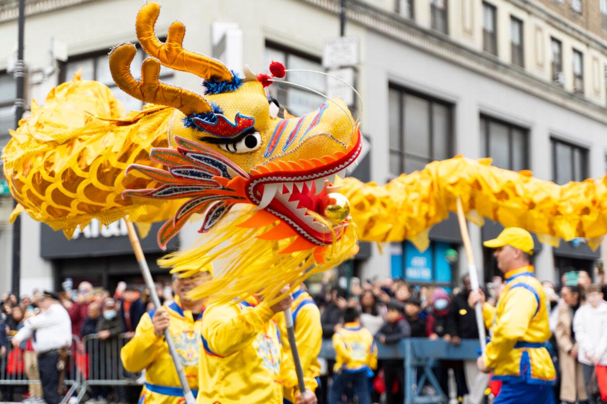Falun Gong practitioners attend a parade celebrating the Chinese New Year, in the Flushing neighborhood of Queens, N.Y., on Feb. 10, 2024. (Chung I Ho/The Epoch Times)