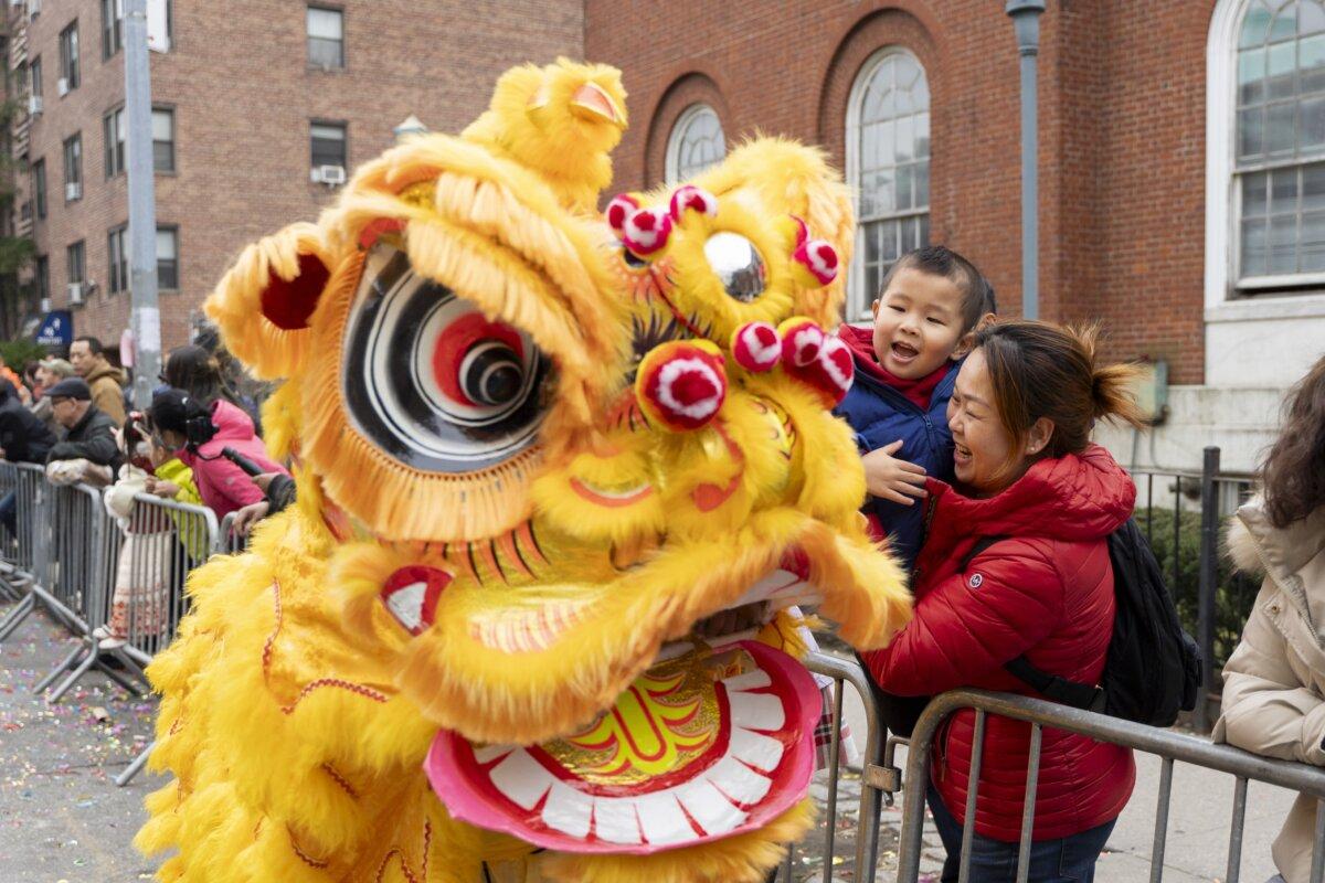 Falun Gong practitioners attend a parade celebrating the Chinese New Year, in the Flushing neighborhood of Queens, N.Y., on Feb. 10, 2024.(Chung I Ho/The Epoch Times)