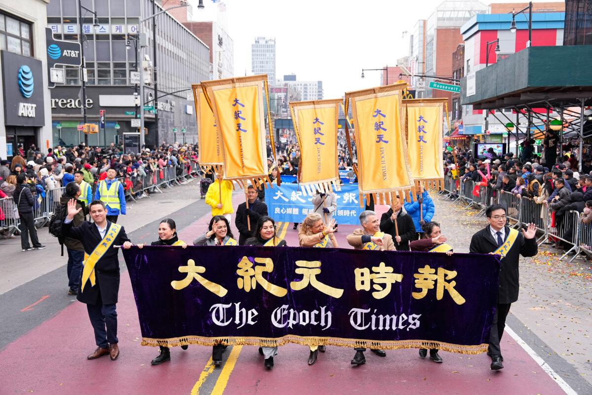The Epoch Times staff attend a parade celebrating the Chinese New Year, in the Flushing neighborhood of Queens, N.Y., on Feb. 10, 2024. (Larry Dye/The Epoch Times)
