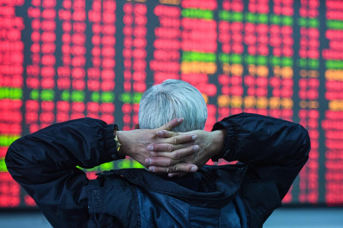 An investor looks at a screen showing stock market movements at a securities company in Hangzhou, China on Feb. 8, 2024. (STR/AFP via Getty Images)