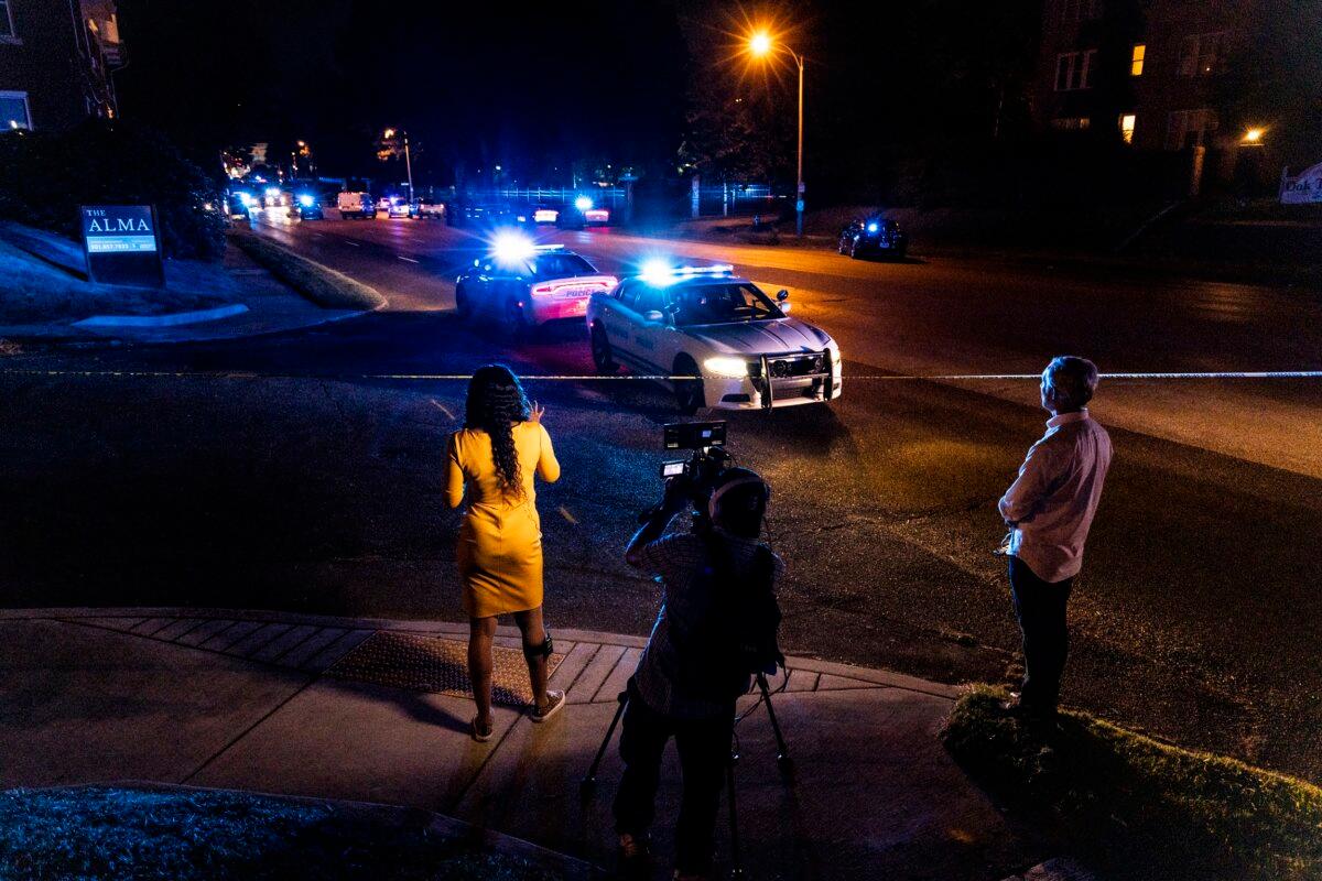 A news crew reports as police investigate the scene of a carjacking apparently connected to a series of shootings in Memphis, on Sept. 7, 2022. (Brad Vest/Getty Images)