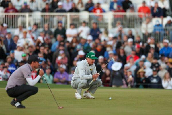 Nick Taylor of Canada (L-R) and Charley Hoffman of the United States prepare to putt on the second-playoff hole during the final round of the WM Phoenix Open at TPC Scottsdale in Scottsdale, Ariz., on Feb. 11, 2024. (Christian Petersen/Getty Images)