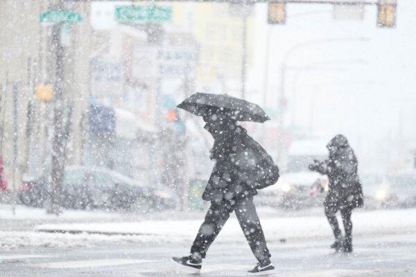 People cross a street during a winter storm in Philadelphia, Pa., on Feb. 13, 2024. (Matt Rourke/AP Photo)