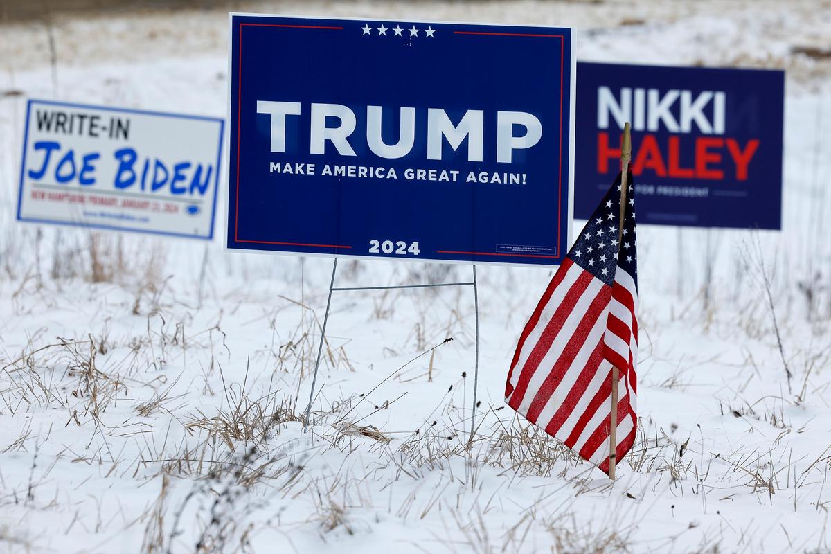 Campaign signs for Republican presidential candidates former President Donald Trump and former U.N. Ambassador Nikki Haley stand next to a sign asking voters to write in President Joe Biden in next Tuesday's primary election in Loudon, N.H., on Jan. 19, 2024. (Chip Somodevilla/Getty Images)