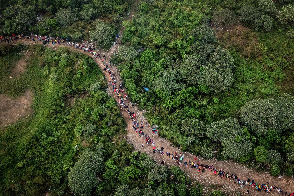 Migrants walk through the jungle near Bajo Chiquito village, the first border control of the Darién Province in Panama, on Sept. 22, 2023. The journey through the Darién Gap usually takes five or six days, at the mercy of all kinds of bad weather. (Luis Acosta/AFP via Getty Images)