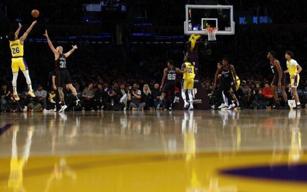 A general view as Spencer Dinwiddie (26) of the Los Angeles Lakers attempts a three-point basket against Evan Fournier (31) of the Detroit Pistons during the third quarter in Los Angeles on Feb. 13, 2024. (Katelyn Mulcahy/Getty Images)