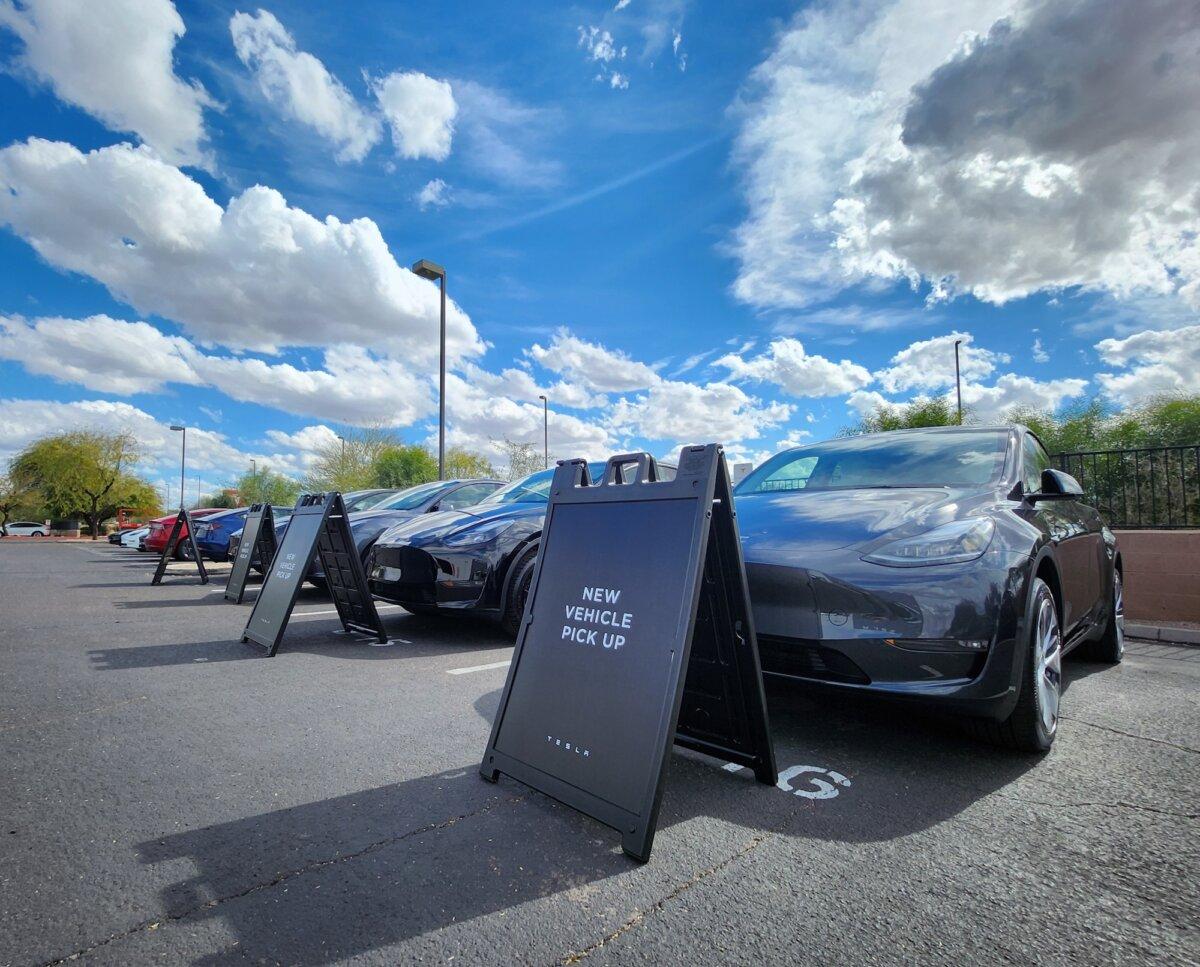 Recently sold Tesla cars wait to be picked up in the parking lot in Phoenix, Ariz., on Feb. 1, 2024. (Allan Stein/The Epoch Times)
