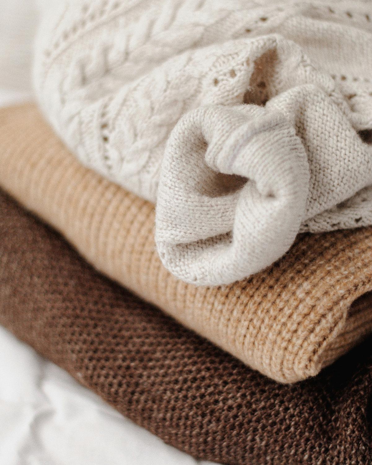Fold your sweaters into a neat pile so that they don't deform. (Kateryna Hliznitsova/Unsplash)