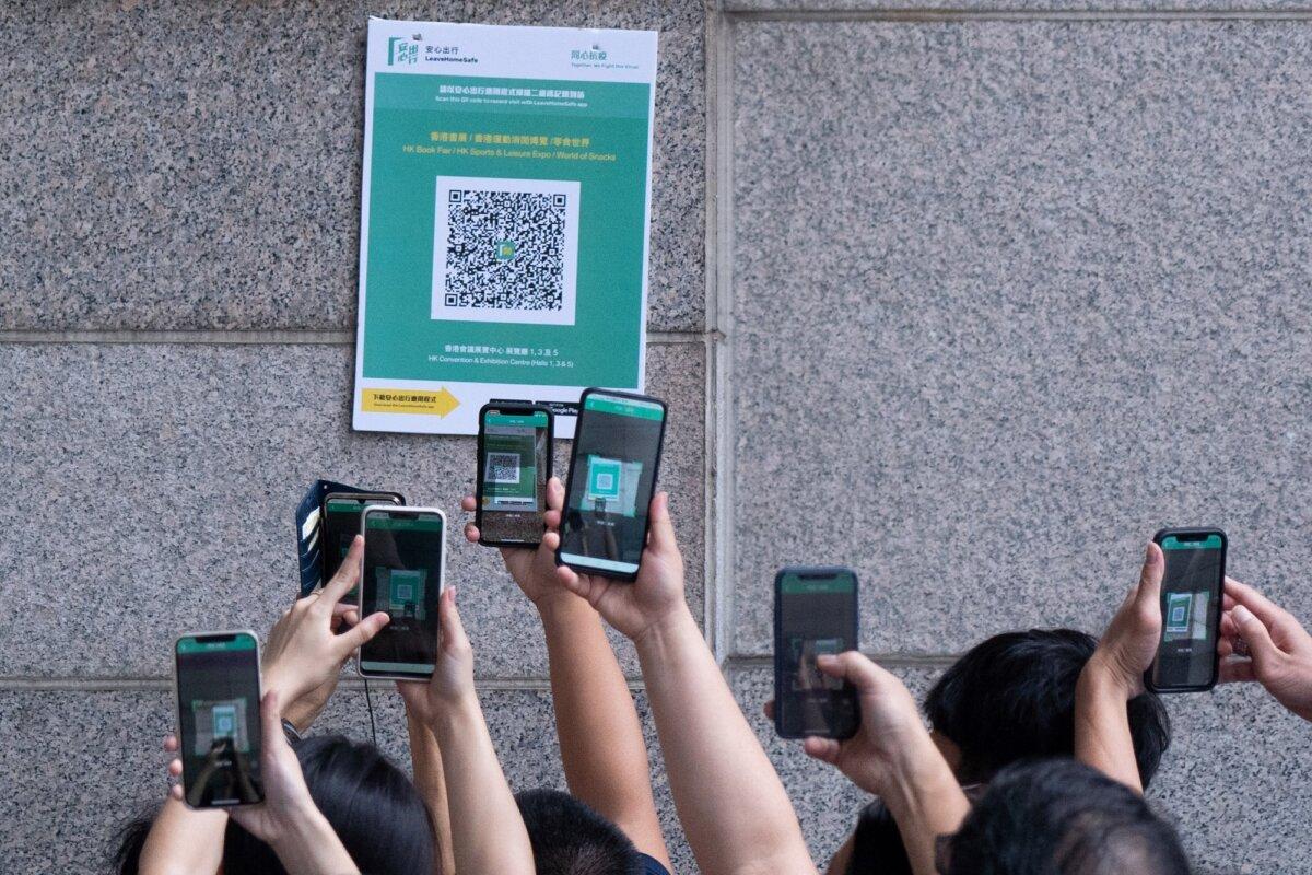 People scan a QR code for a Hong Kong government app to trace people in case of COVID-19 outbreaks in Hong Kong on July 17, 2021. (Bertha Wang/AFP via Getty Images)