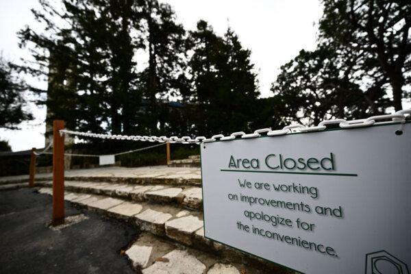An area closed sign is displayed outside the Wayfarers Chapel in a landslide-prone area following its closure due to land movement after heavy rains in Rancho Palos Verdes, Calif., on Feb. 16, 2024. (Patrick T. Fallon/AFP via Getty Images)