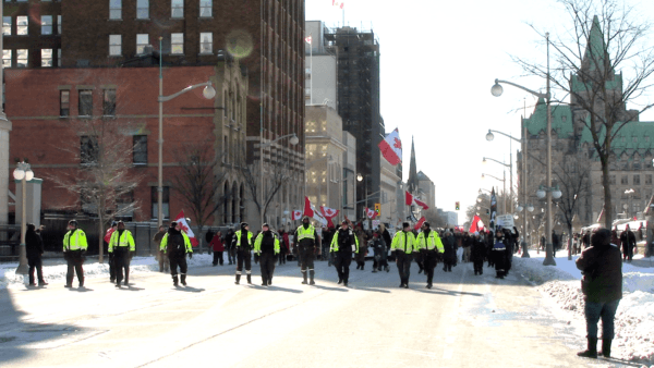 Protesters march in downtown Ottawa to mark the two-year anniversary of the Freedom Convoy protest, on Feb. 17, 2024. (Annie Wu/NTD)