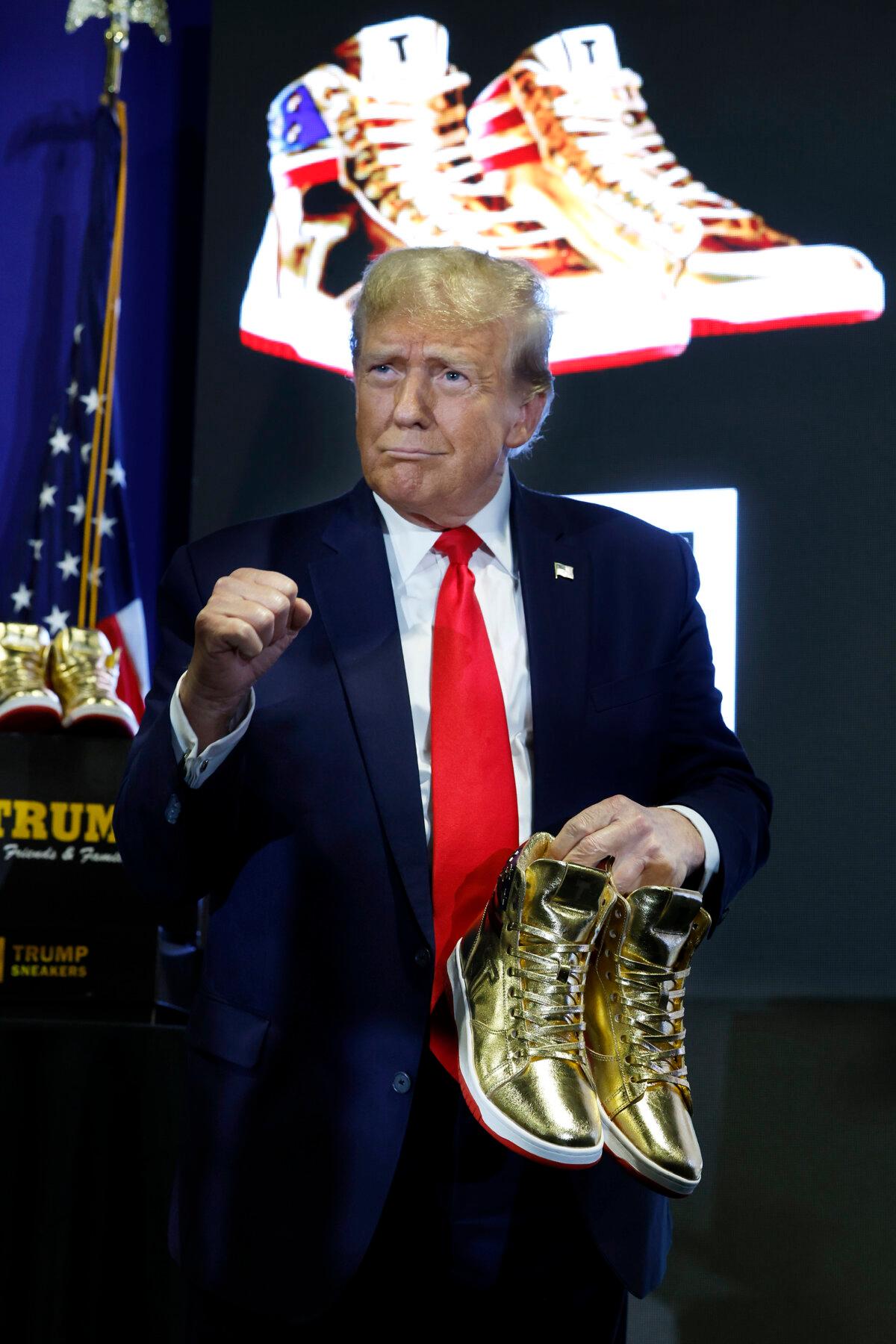 Republican presidential candidate and former President Donald Trump holds a pair of his new line of signature shoes after taking the stage at Sneaker Con at the Philadelphia Convention Center in Philadelphia on Feb. 17, 2024. (Chip Somodevilla/Getty Images)