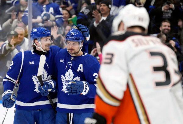 Toronto Maple Leafs' Auston Matthews (L) is congratulated by Simon Benoit after scoring his third goal against the Anaheim Ducks during the second period of an NHL hockey game in Toronto on Feb. 17, 2024. (Chris Young/The Canadian Press via AP)