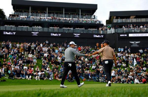 Patrick Cantlay of the United States reacts to his putt with Xander Schauffele of the United States on the 18th green during the final round of The Genesis Invitational at Riviera Country Club in Pacific Palisades, Calif., on Feb. 18, 2024. (Ronald Martinez/Getty Images)