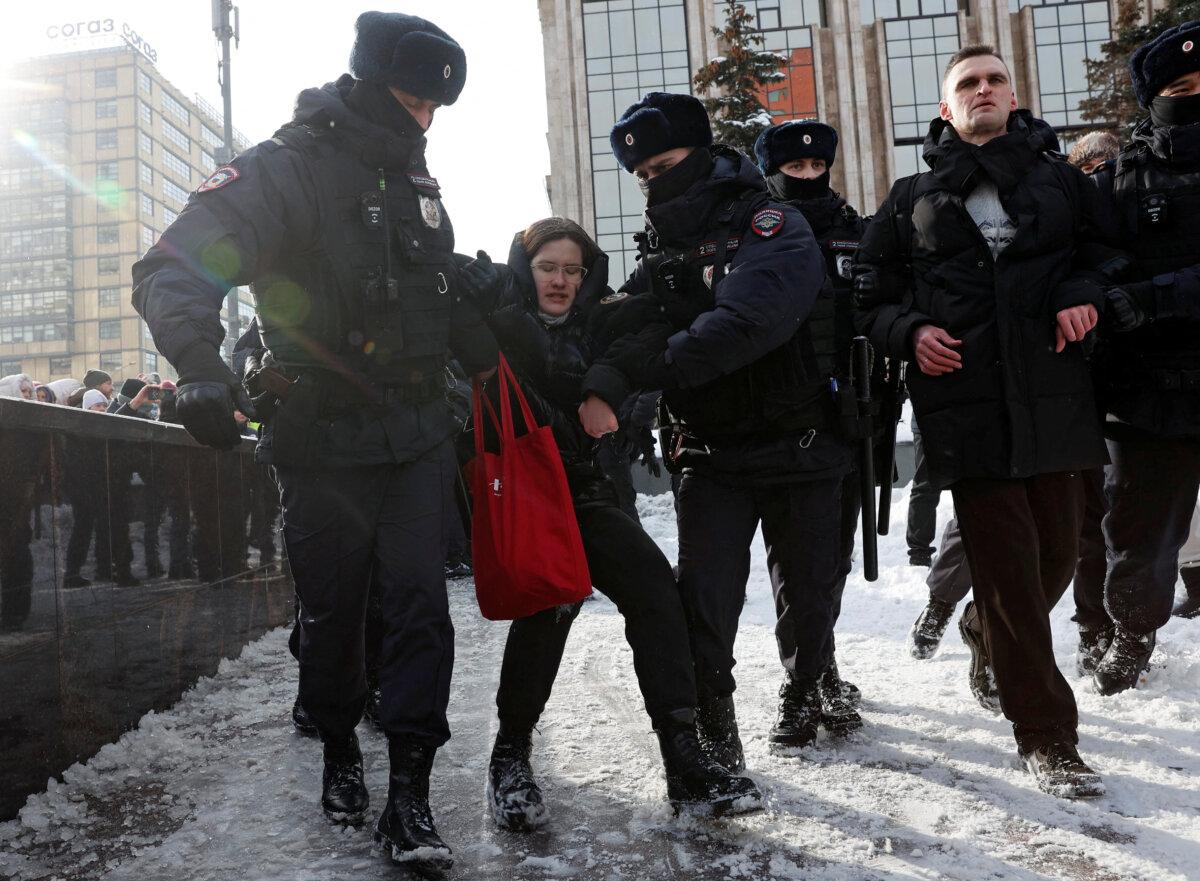 Police officers detain people during a gathering in memory of Russian opposition leader Alexei Navalny near the Wall of Grief monument to the victims of political repressions in Moscow, on Feb. 17, 2024. (Stringer/Reuters)
