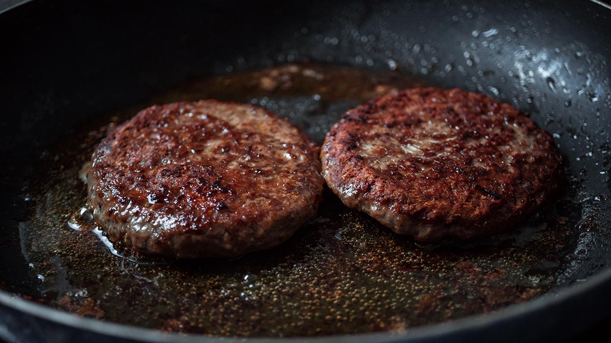 Sear the patties hot and fast for a flavorful crust and juicy interior. (Vladimir _Woffka_ Lebedev/Shutterstock)