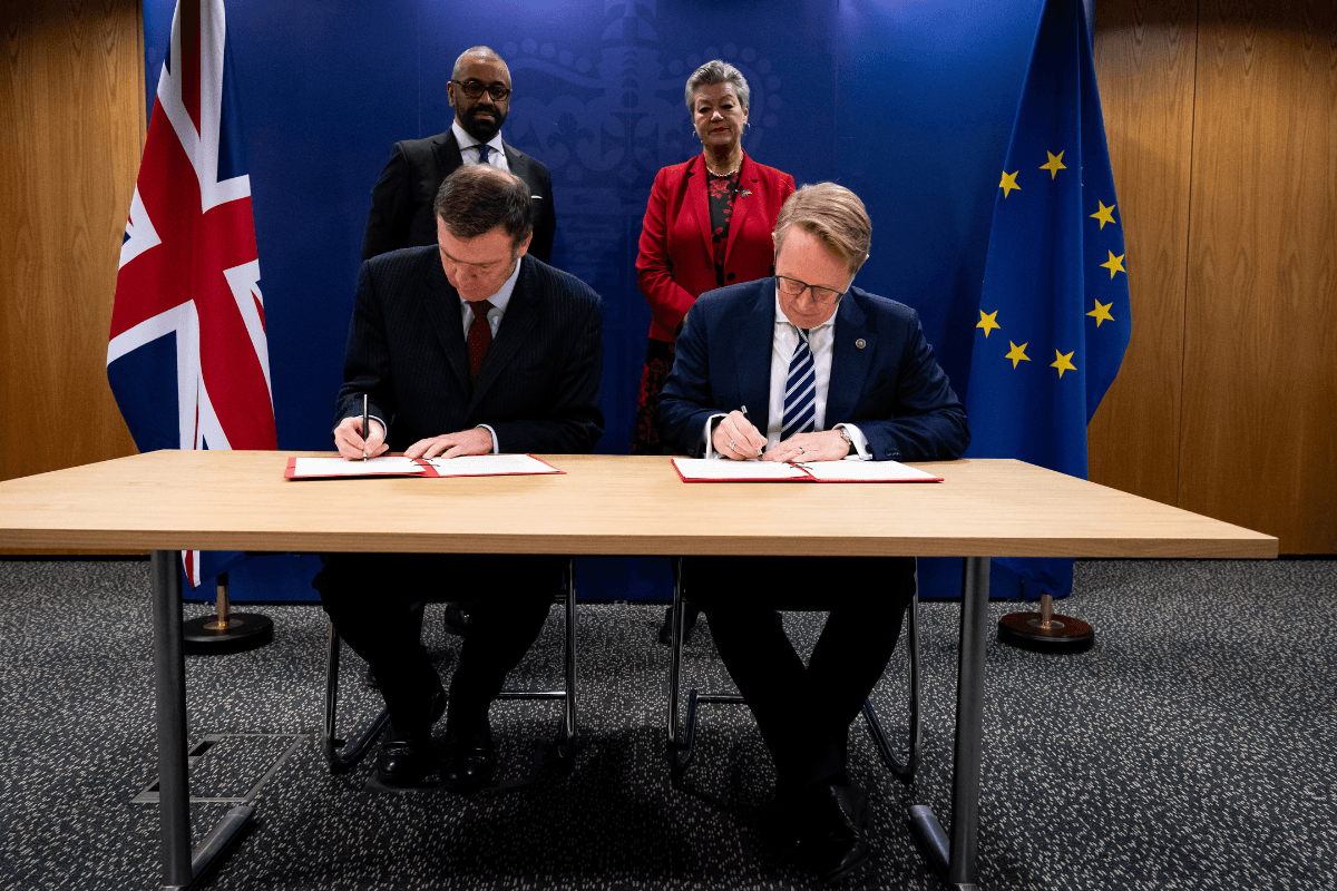 (Front, left to right) Director General of Border Force Phil Douglas and Executive Director of Frontex Hans Leijtens sign a document watched by (back, left to right) Home Secretary James Cleverly and European Commissioner for Home Affairs Ylva Johansson, at the Home Office, in central London, on Feb. 23, 2024. (Aaron Chown/PA Media)