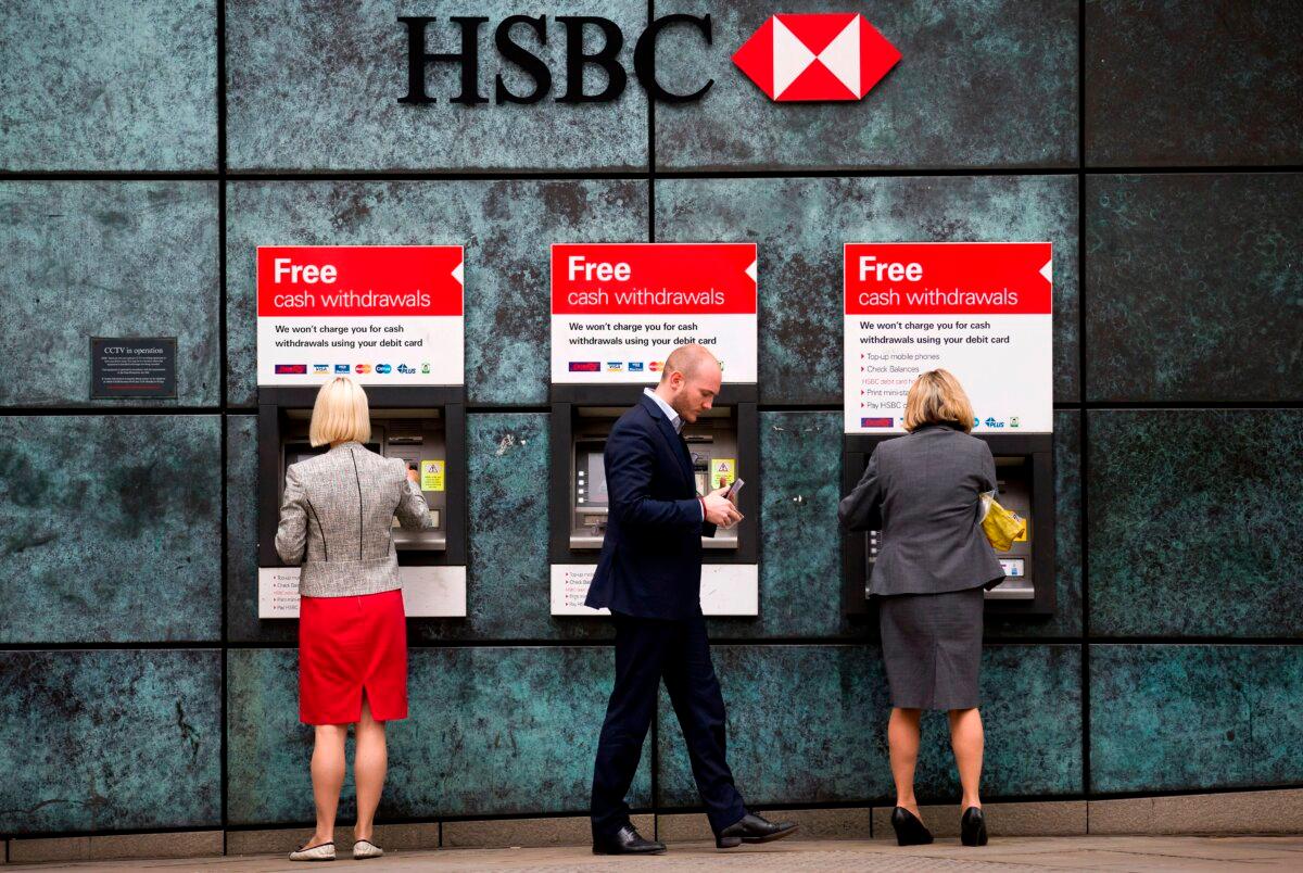 Customers use ATMs outside an HSBC branch in London on June 9, 2015. (Justin Tallis/AFP via Getty Images)