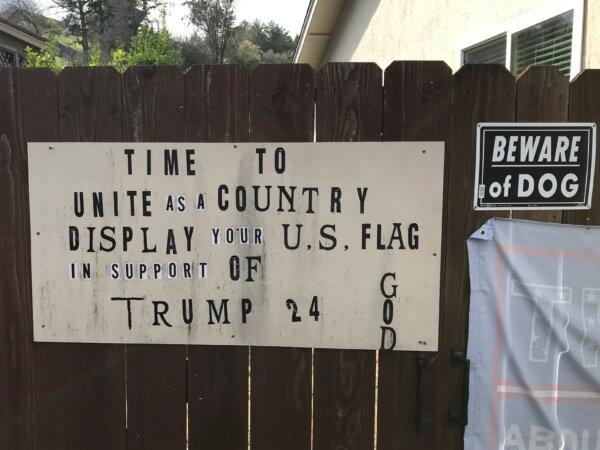 A homemade sign in support of God, the country, and Donald Trump on Mike Briard’s fence in Martinez, Calif., on Feb. 6, 2024. (Keegan Billings/The Epoch Times)