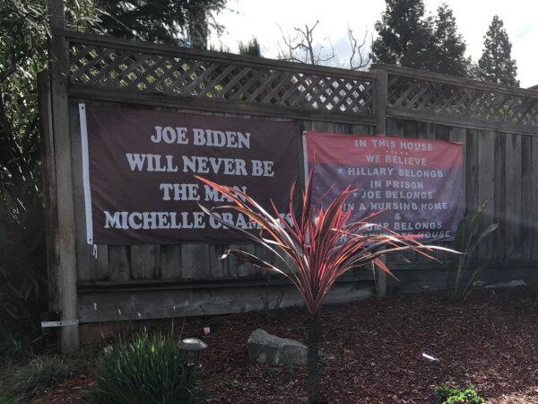 Banners on Mike Briard’s fence in Martinez, Calif., on Feb. 6, 2024. (Keegan Billings/The Epoch Times)