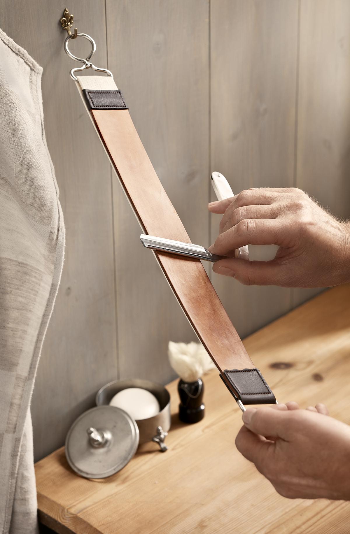 A razor strop, or flexible strip of leather used to polish the blade of a straight razor. (addimage/Shuttestock)